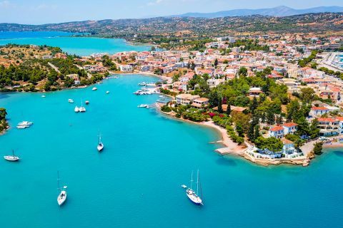 Turquoise waters, beautiful houses and vegetation. View of Porto Heli.